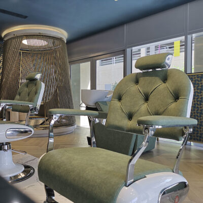 A creative beauty salon features modern lighting fixtures and colorful accent walls.
