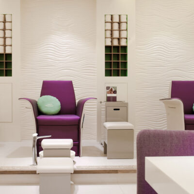 The salon's vibrant color scheme adds energy and excitement to the space.