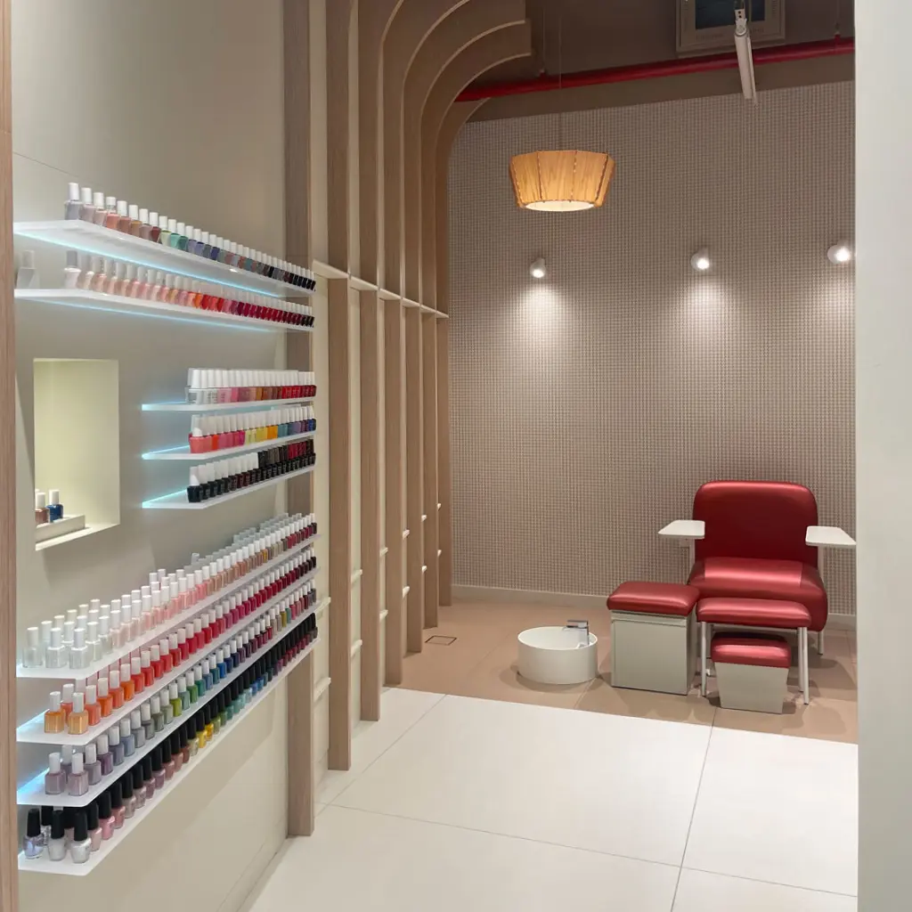A Dubai Nail spa salon interior design with a wall display and a service seat