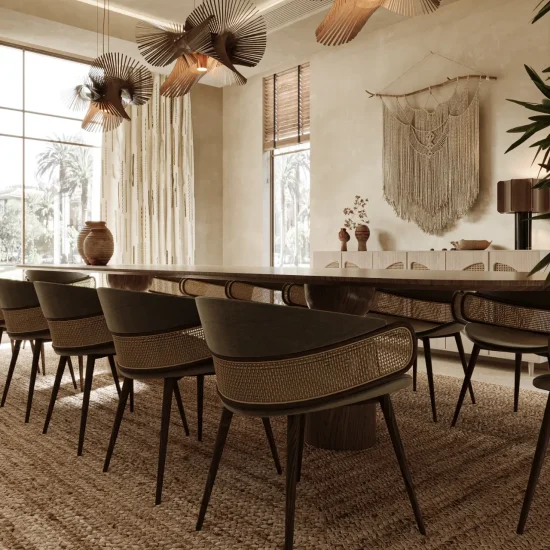 Modern farmhouse dining room in Dubai featuring a long wood table, cane-back dining chairs, woven jute rug, sculptural pendant lights, and soft beige plaster walls.