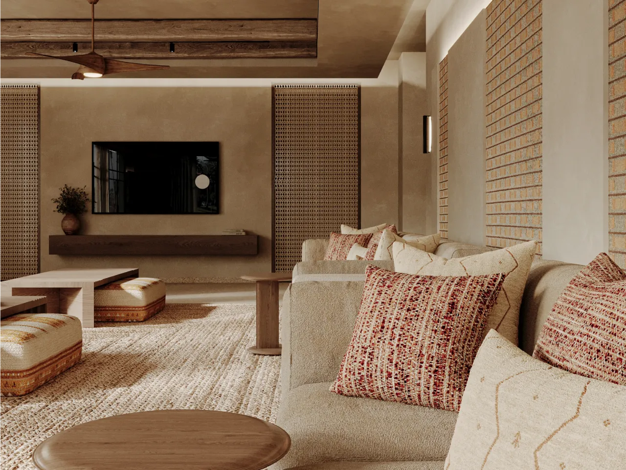 Modern farmhouse majlis seating in Dubai with continuous sectional sofa, textured throw pillows, wall-mounted TV, cane wall panels, and warm beige plaster finishes