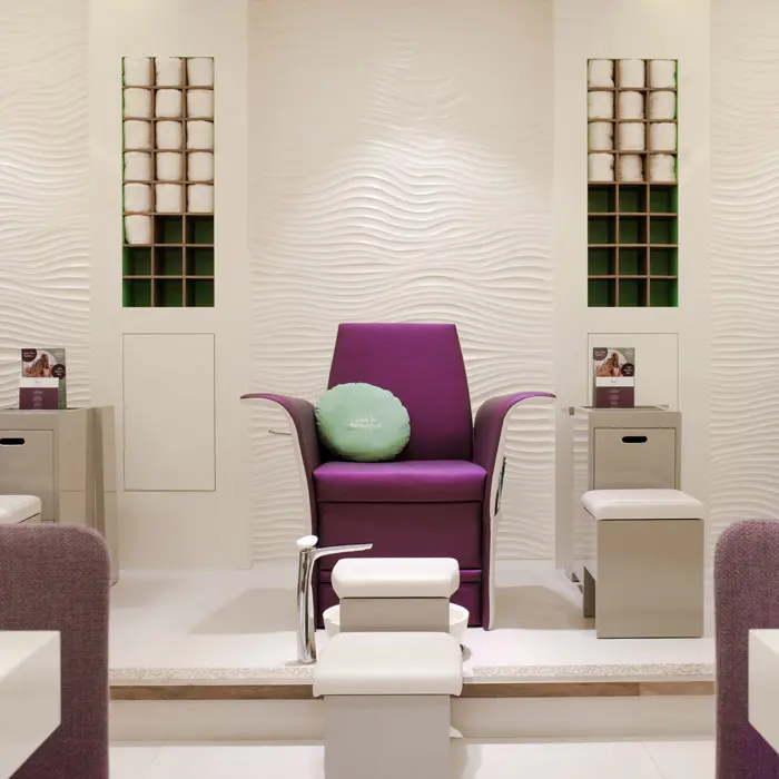 A white beauty salon interior design in Dubai with unique armchairs