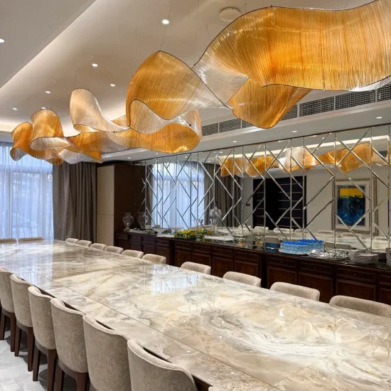 Long formal dining room after renovation with stone dining table, upholstered chairs, mirrored feature wall